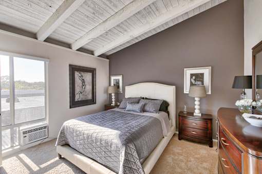 a bedroom with a bed and a painting on the wall at Mediterranean Village Costa Mesa, Costa Mesa, CA, 92626