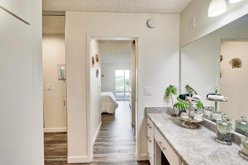 an open kitchen with a large mirror and a hallway to a bedroom at Mediterranean Village Costa Mesa, Costa Mesa