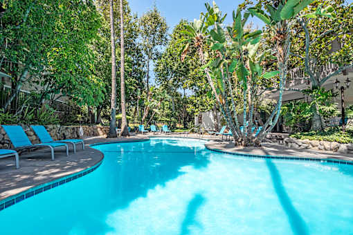 a swimming pool at a resort with trees and chairs  at Rancho Los Feliz, Los Angeles