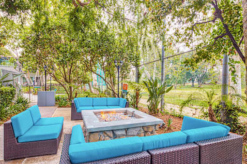 a lounge area with blue couches and a fire pit  at Rancho Los Feliz, California
