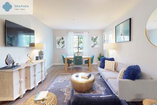 A living room with a white couch, a yellow coffee table, and a large mirror on the wall at Mission Hills, Camarillo, 93012