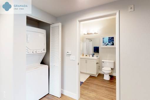 A white washing machine is in a small room with a toilet and a cabinet at Mission Hills, Camarillo, 93012