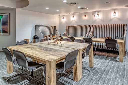 A conference room with a long wooden table surrounded by chairs at Esprit Marina del Rey, 90292