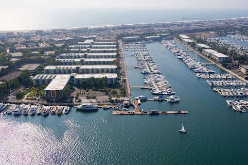 A marina with boats docked and a building in the background.