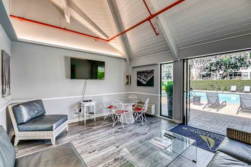 A modern living room with a pool outside.