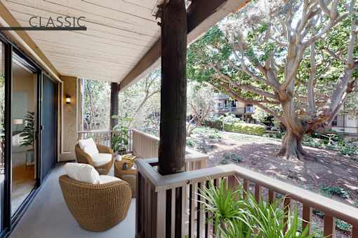 A balcony with a chair and a table with a sign that says at Mariners Village, Marina del Rey, 90292