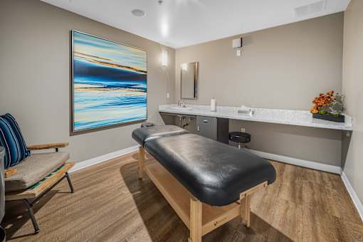 A room with a massage table and a painting on the wall at Esprit Marina del Rey, 90292