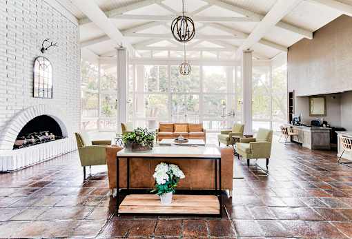 A living room with a fireplace and a dining table.