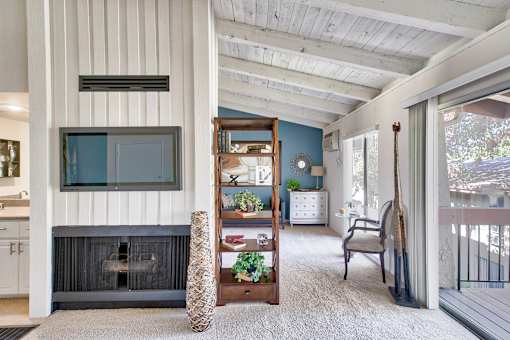 A living room with a fireplace and a chair.