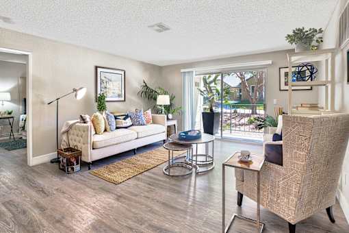 A living room with a white sofa and a wooden coffee table.