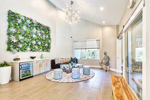 A living room with a green wall and a wooden bench.