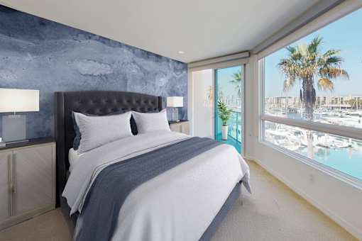 A bedroom with a large bed and a view of a marina at Esprit Marina del Rey, 90292