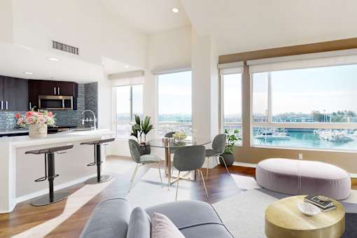 A modern living room with a bar area and a view of the water at Esprit Marina del Rey, 90292