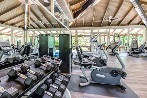 A gym with a variety of equipment including treadmills, dumbbells, and weight machines at Rancho Los Feliz, Los Angeles, California
