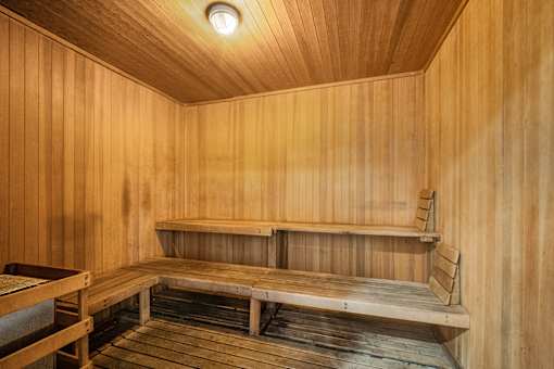 A wooden sauna with a bench and a light on the ceiling at Esprit Marina del Rey, 90292