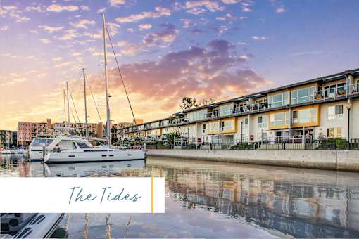 A serene waterfront scene with boats docked and a building in the background at Marina Harbor, California, 90292
