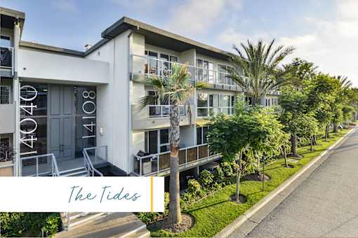 The Tides is a modern apartment complex with white buildings and palm trees at Marina Harbor, California, 90292