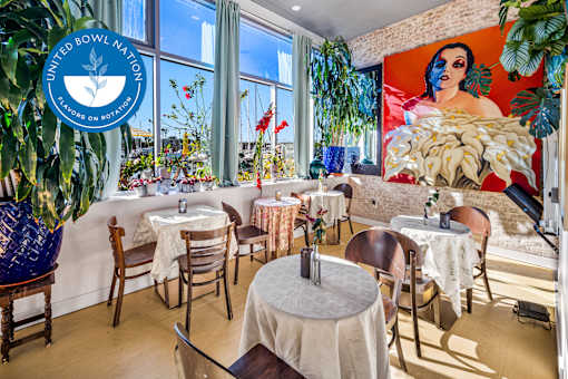 A restaurant with tables and chairs and a United Nations sign at Esprit Marina del Rey, 90292