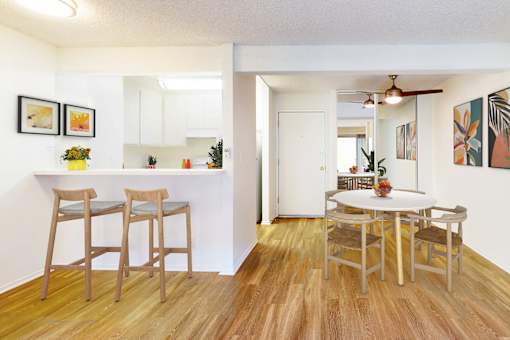 A dining room with a table and chairs at Village Pointe Apartments, Northridge, California