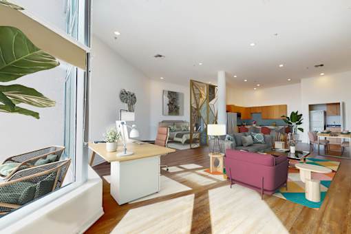 A living room with a pink couch and a white coffee table at Esprit Marina del Rey, 90292