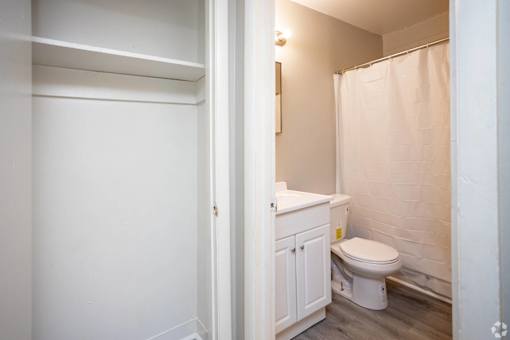A white toilet sits in a small bathroom.