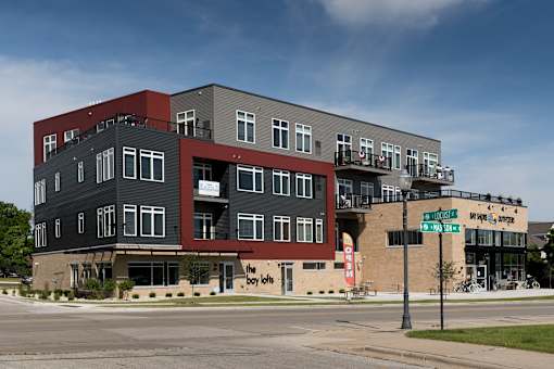 A multi-story building with a red and black exterior.