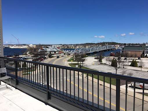 A view from a balcony overlooking a bridge and a river.
