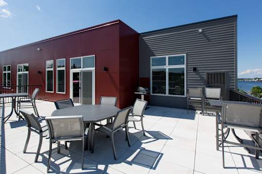 A patio with a table and chairs is set up outside a building.