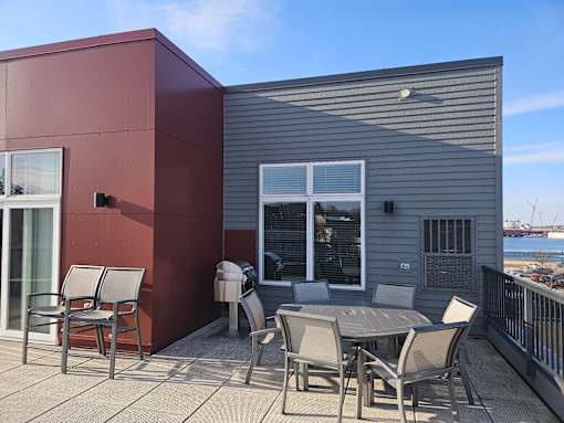 A patio with a table and chairs is on a balcony.