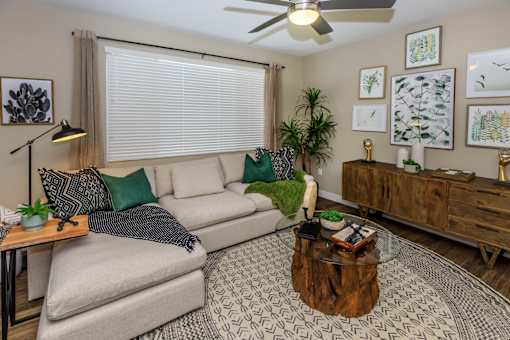 a living room with a couch and a coffee table at Level 25 at The Curve by Picerne, Las Vegas, NV
