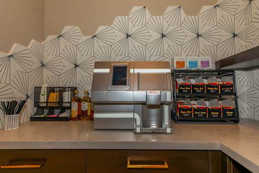 a kitchen with a coffee maker and drinks on the counter at Level 25 at The Curve by Picerne, Nevada