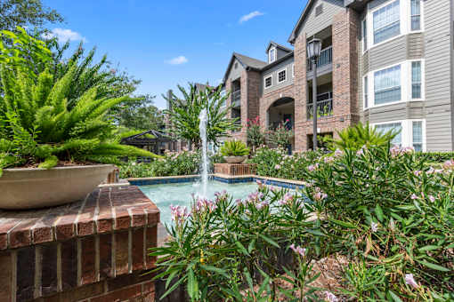 Fountain feature by our impressive apartment homes at Asheville at Spring Branch apartments in Houston, TX