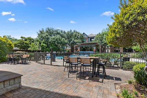 Poolside seating at Asheville at Spring Branch apartments in Houston, TX