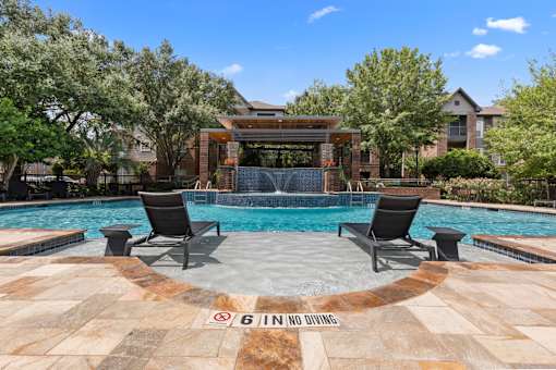 Our sparkling pool has in-pool lounge chairs at Asheville at Spring Branch apartments in Houston, TX