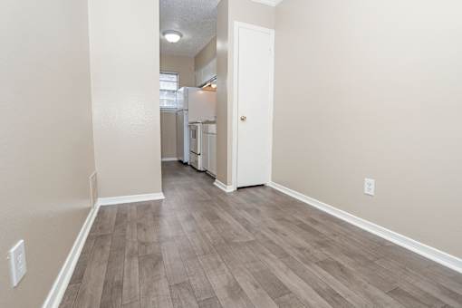 A dining room that leads to a kitchen  at The Creole Apartments in Shreveport, LA
