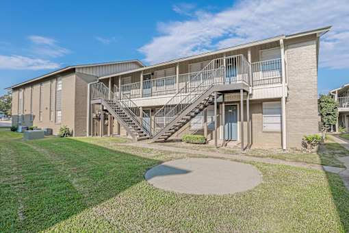 A modern apartment building with a staircase leading to the second floor  at The Creole Apartments in Shreveport, LA