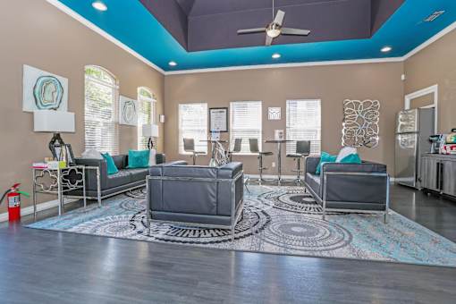 A clubhouse with a grey sofa set and a rug at The Drake in Bossier City, LA