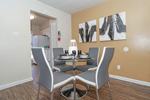 A dining room with a table set for four at The Drake in Bossier City, LA