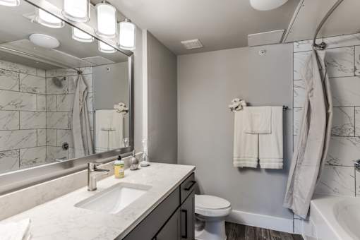 A2 model bathroom with white quartz countertops at Asheville at Spring Branch apartments in Houston, TX