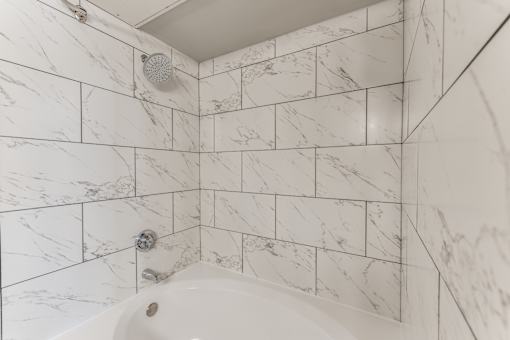 A2 model bathroom shower with oversized tub at Asheville at Spring Branch apartments in Houston, TX