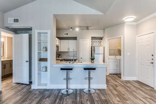A2 model kitchen and dining area with stainless steel appliances at Asheville at Spring Branch apartments in Houston, TX