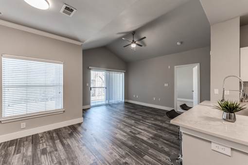 A2 model living area showcasing open concept and vaulted ceiling at Asheville at Spring Branch apartments in Houston, TX
