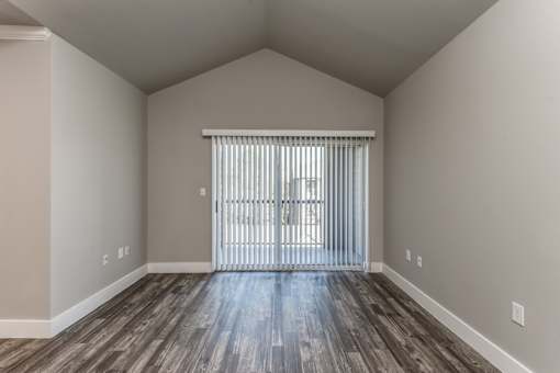 A2 model large living room space with sliding door leading to patio or balcony at Asheville at Spring Branch apartments in Houston, TX