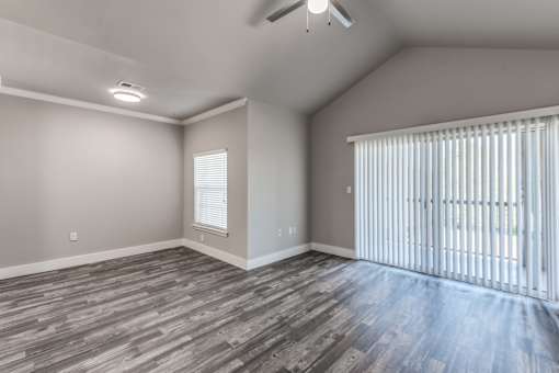 A2 model living room with sliding door leading to patio or balcony at Asheville at Spring Branch apartments in Houston, TX