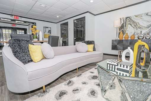 Comfy couch in clubhouse lounge area at Maplewood apartments in Shreveport, LA.