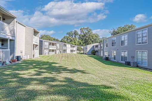 A sunny day showcasing our beautiful landscaping in the apartment complex at Maplewood apartments in Shreveport, LA.