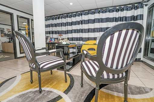 Two striped chairs in the leasing office at Maplewood apartments in Shreveport, LA.