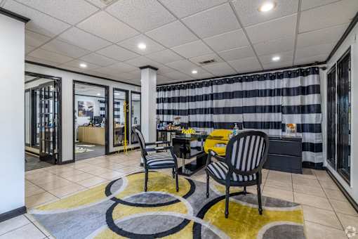 Interior of leasing office with desks and seating at Maplewood apartments in Shreveport, LA.