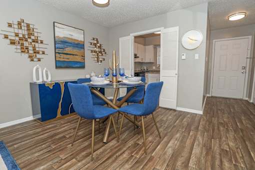 A dining room with a table and chairs at The Oasis apartments in Bossier City, LA