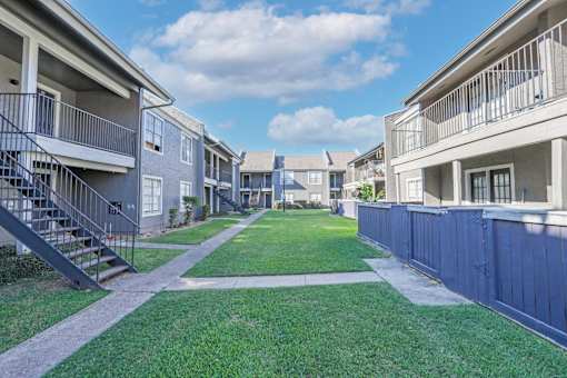 Walkways leading to our apartments with beautifully maintained grounds at The Oasis apartments in Bossier City, LA